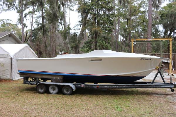 Blackfin Custom 25 2018 Blackfin Custom 25 boat on trailer, parked outdoors near trees.