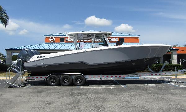Wellcraft 352 Fisherman 2024 Wellcraft 352 Fisherman boat on a trailer in a parking lot.
