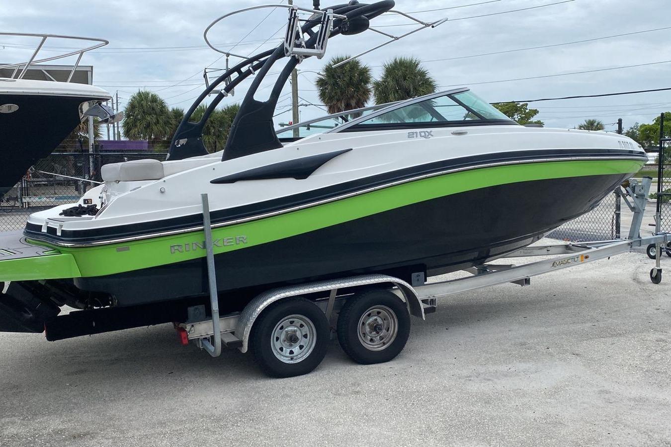 Rinker 21QX BR 2019 Rinker 21QX BR boat on trailer, featuring sleek design and vibrant green accents.