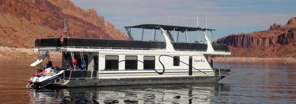 Sumerset Houseboats Desert Rain Share #15 Houseboat Desert Rain Trip 15 by American Waterways, 2006, on a serene lake with rocky cliffs.
