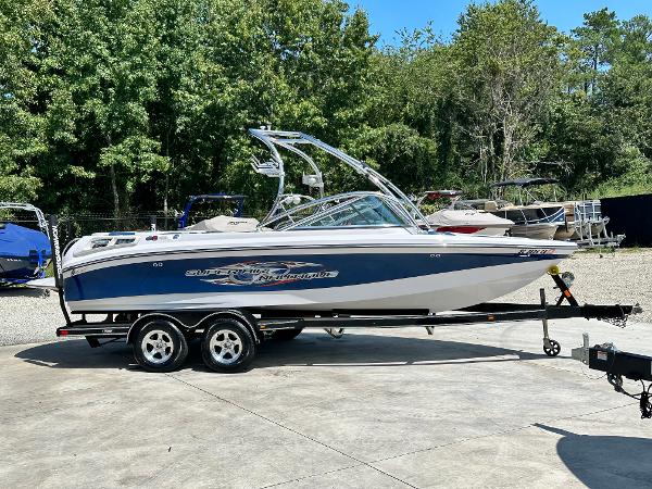 Nautique Super Air 210 2008 Nautique Super Air 210 boat on trailer, parked outdoors.