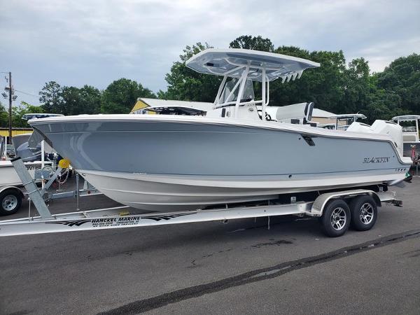 Blackfin 252CC 2024 Blackfin 252CC boat on a trailer at a marina.
