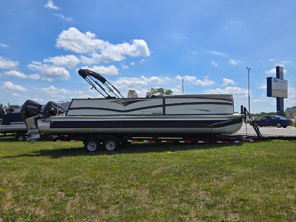 Premier 270 Intrigue RL 2023 Premier 270 Intrigue RL pontoon boat on trailer under blue sky.