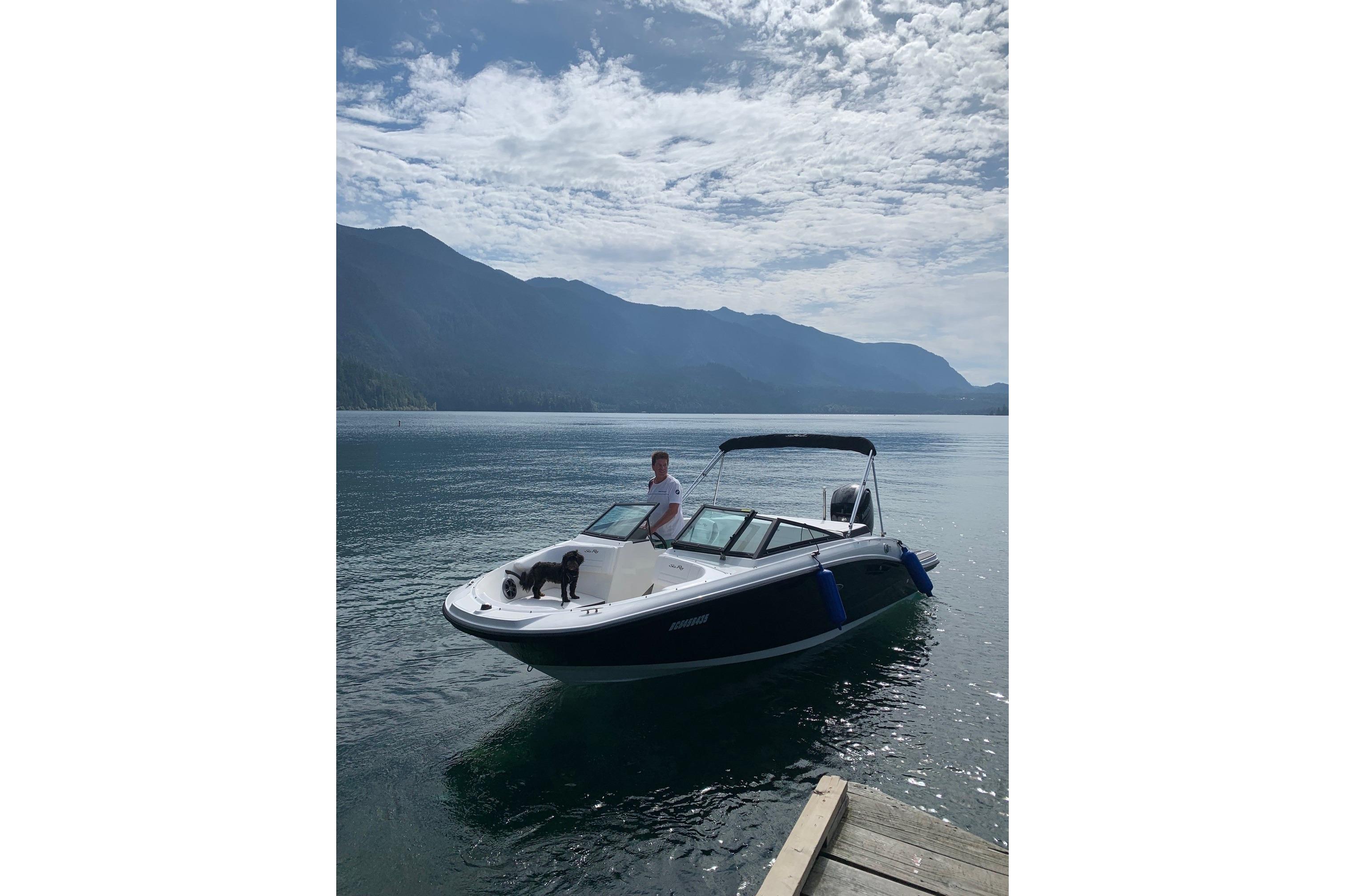 Sea Ray SPX 190 2019 Sea Ray SPX 190 boat on a serene lake with mountains in the background.