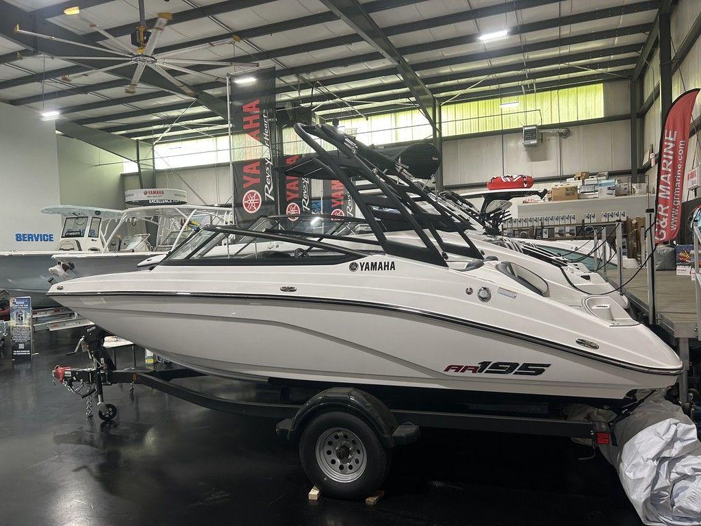 Yamaha Boats AR195 2025 Yamaha AR195 boat displayed in showroom, sleek design, on trailer.