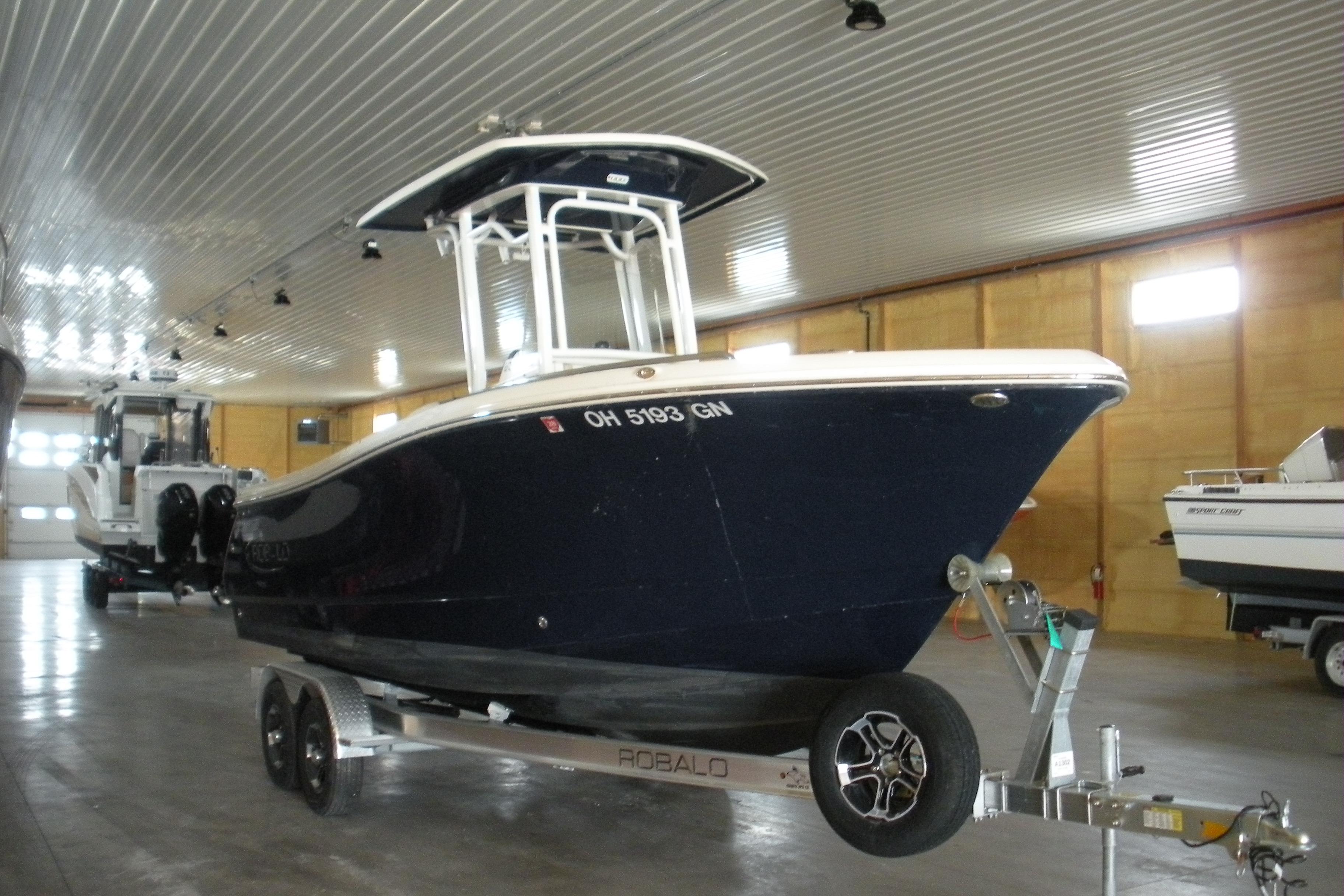 Robalo R230 Center Console 2025 Robalo R230 Center Console boat on trailer in indoor storage facility.