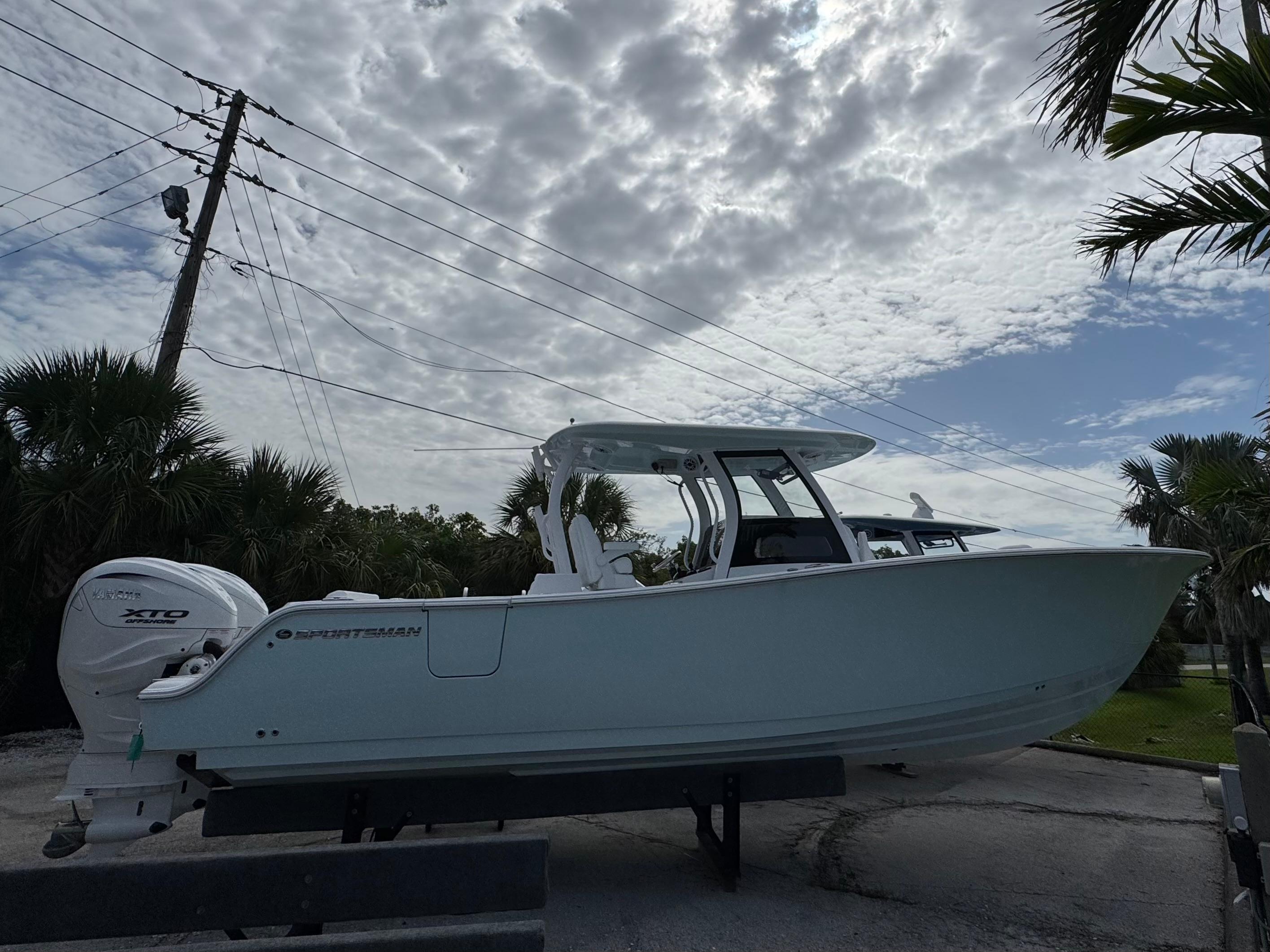 Sportsman Open 322 Center Console 2025 Sportsman Open 322 Center Console boat on trailer under cloudy sky.