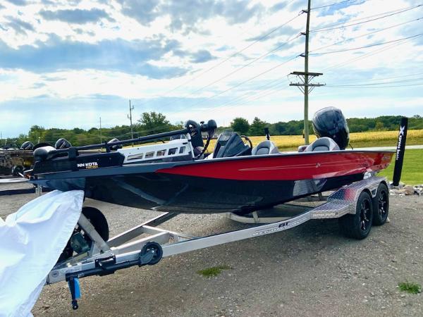 Xpress X19 Pro 2024 Xpress X19 Pro boat on trailer, red and black design, parked outdoors.