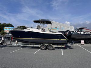 Grady-White F-26 Tigercat 1999 Grady-White X-26 boat on trailer, parked in a lot under a clear sky.