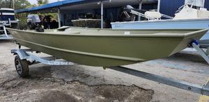 Lowe L1448 Jon 2025 Lowe Jon L1448 boat on trailer, parked outdoors.