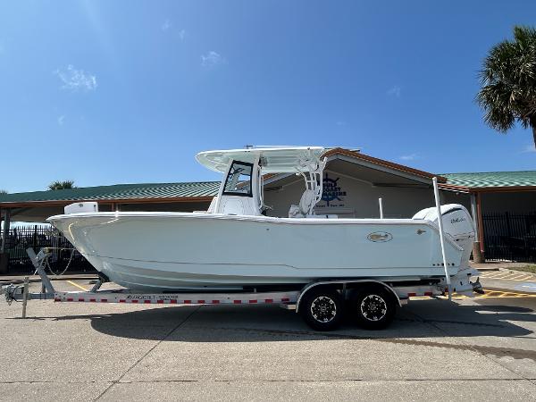 Sea Hunt Gamefish 28 Coffin Box 2025 Sea Hunt Gamefish 28 with Coffin Box on trailer, parked outdoors under clear sky.