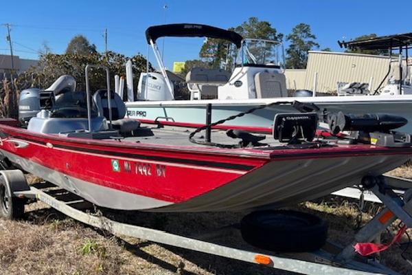 G3 176 EAGLE 2014 G3 176 EAGLE red fishing boat on trailer, parked outdoors.