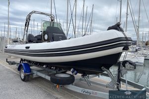 3D Tender Dream 6 2022 3D Tender Dream 6 boat on trailer at marina, overcast sky.