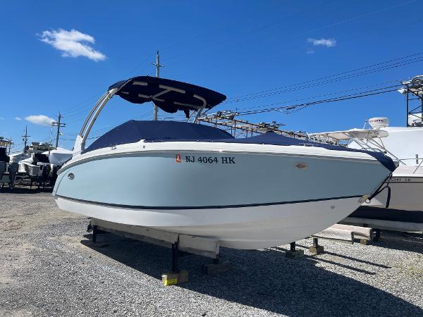 Cobalt R5 2016 Cobalt R5 boat on display, blue hull, covered, sunny day, gravel lot.