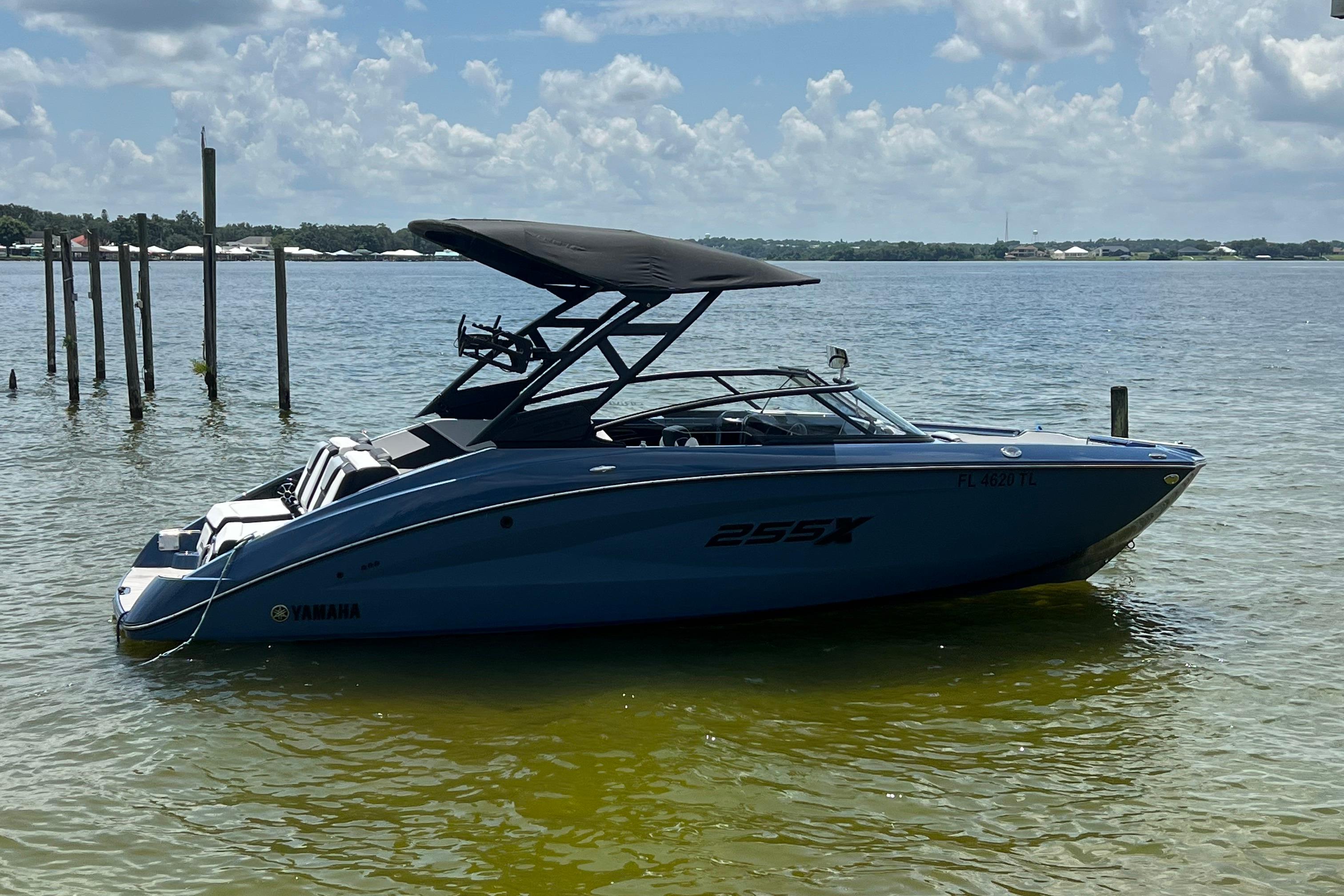 Yamaha Boats 255XD 2023 Yamaha Boats 255XD in water, sleek design, blue hull, sunny day.