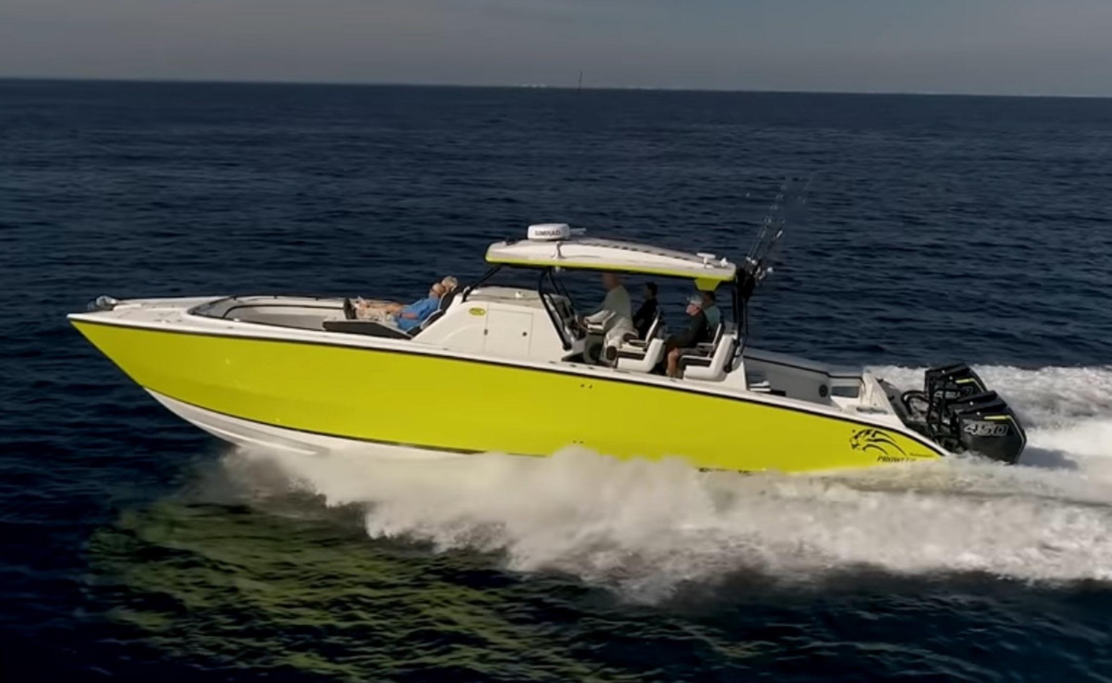 Prowler 42 2020 Prowler 42 boat cruising on open water, vibrant yellow hull, multiple passengers onboard.