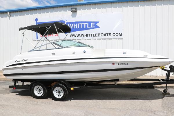 Chris-Craft 232 2000 Chris-Craft 232 boat on trailer, parked outside Whittle Boats dealership.
