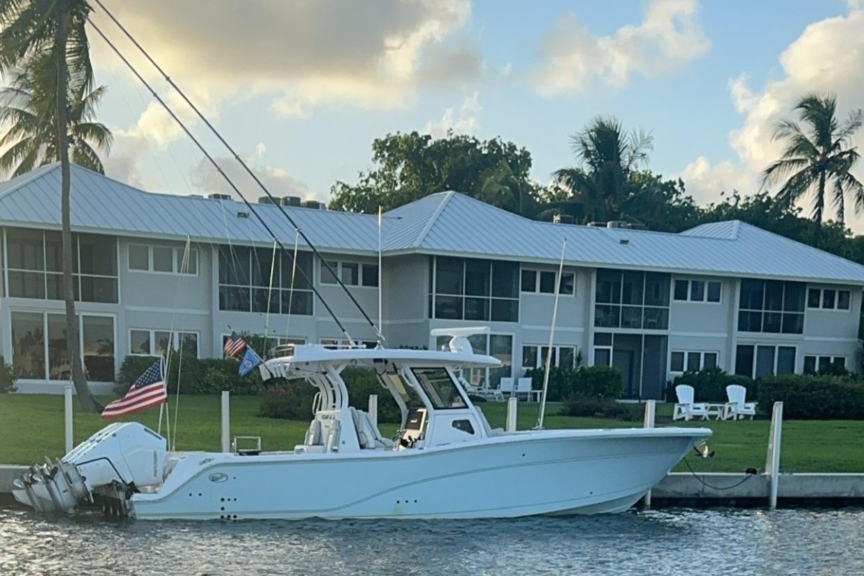 Sea Fox 368 Commander 2023 Sea Fox 368 Commander boat docked near waterfront homes.