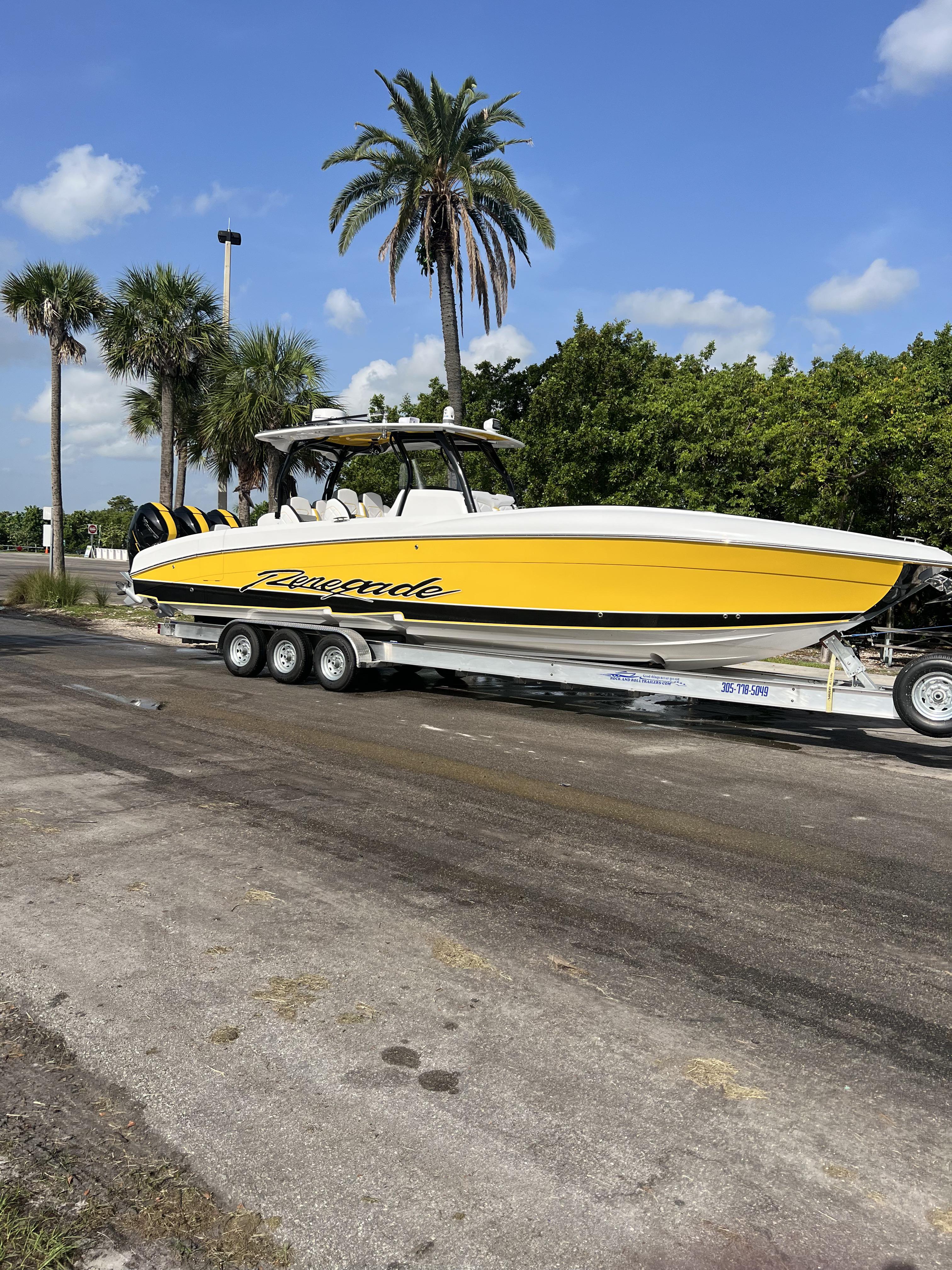 Renegade 38' Open 2023 Renegade 38' Open boat on trailer, yellow and white, palm trees in background.