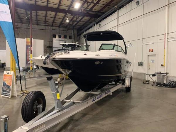 Sea Ray SLX 250 2014 Sea Ray SLX 250 boat on trailer in indoor showroom.