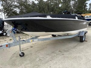 Bayliner Element E18 2025 Bayliner Element E18 boat on trailer, covered and parked outdoors.