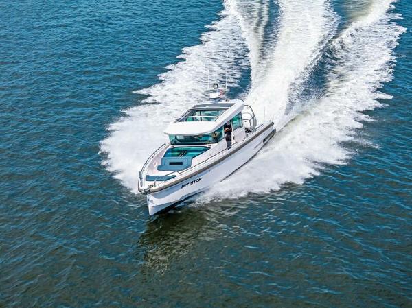Axopar 37 XC CROSS CABIN 2022 Axopar 37 Cross Cabin cruising on open water, creating a dynamic wake.