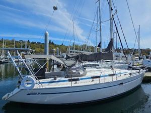 Bavaria 37 Cruiser 2002 Bavaria 37 Cruiser sailboat docked in a marina under a clear blue sky.