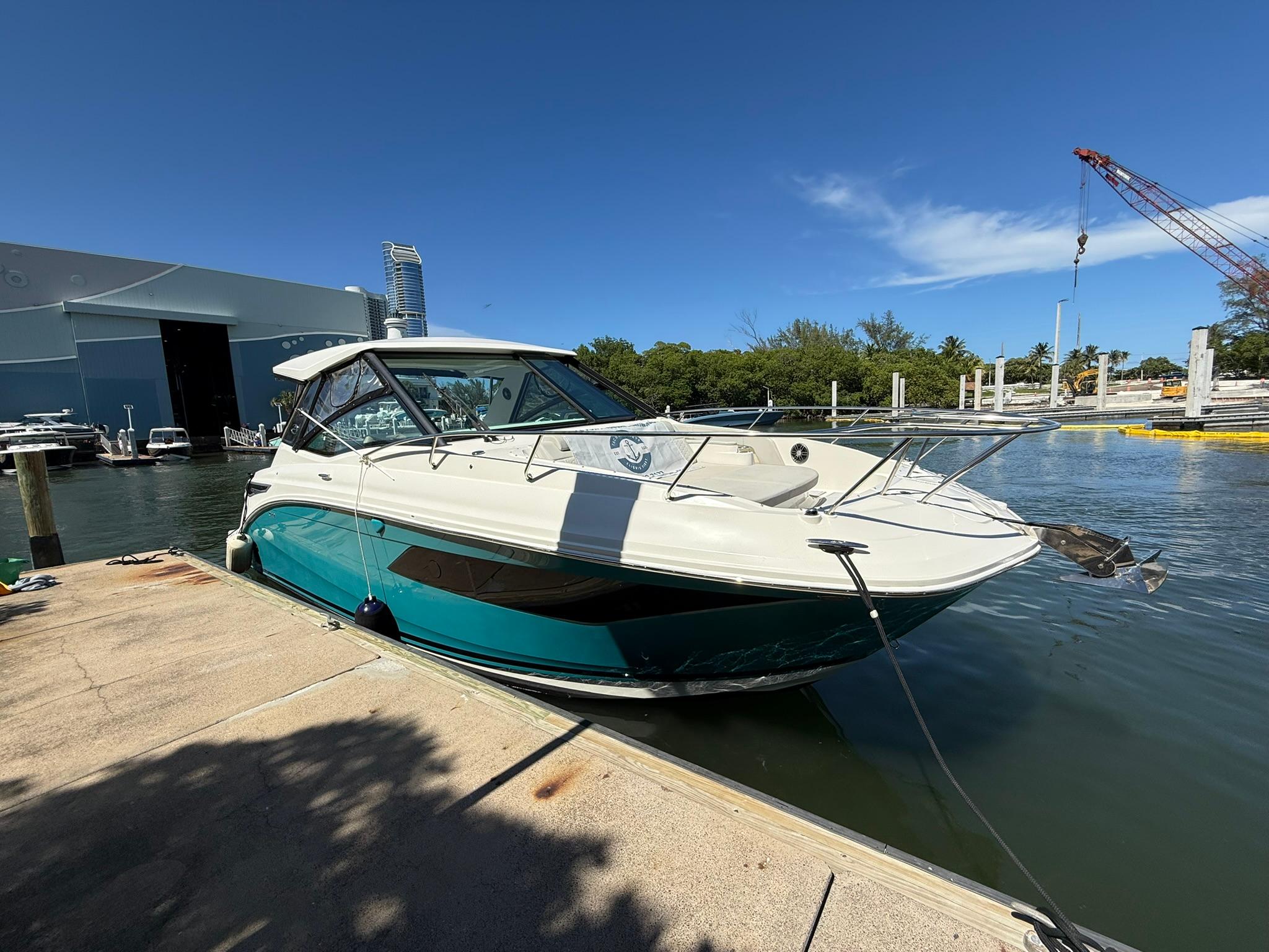 Sea Ray Sundancer 320 Outboard 2022 Sea Ray Sundancer 320 Outboard docked at marina under clear blue sky.