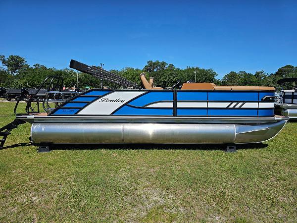 Bentley Pontoons 223 Elite Swingback Dual Captain Full Tritoon 2025 Bentley Pontoons 223 Elite Swingback Dual Captain Full Tritoon on grass, side view.