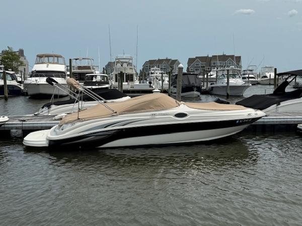 Sea Ray 240 Sundeck 2003 Sea Ray 240 Sundeck boat docked in a marina with other vessels.