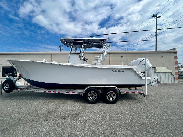 Pair Customs 28 Center Console 2025 Pair Customs 28 Center Console boat on trailer, parked outdoors under cloudy sky.