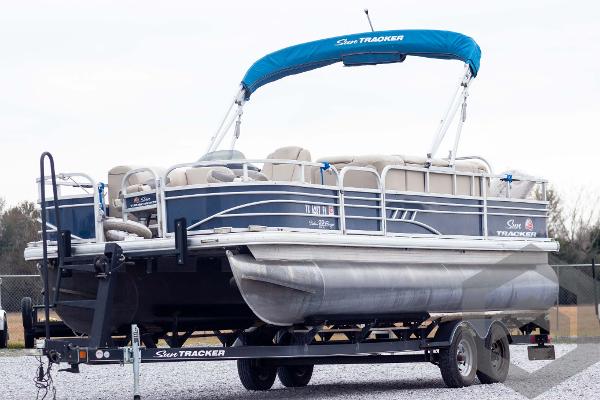 Sun Tracker Fishin' Barge 22 DLX 2020 Sun Tracker Fishin' Barge 22 DLX pontoon boat on trailer.