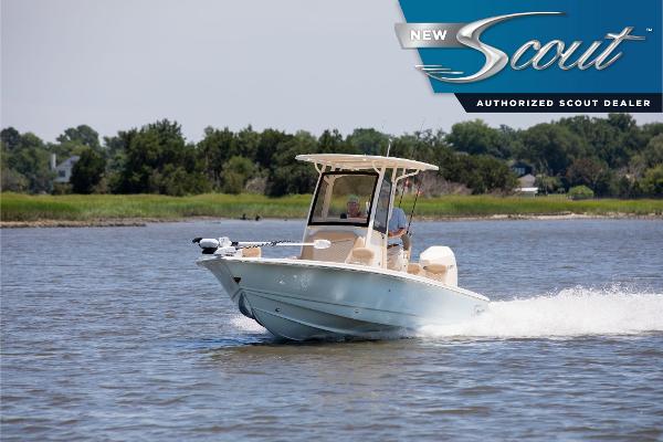 Scout 231 XSB 2025 Scout 231 XSB boat cruising on a serene lake with lush greenery in the background.