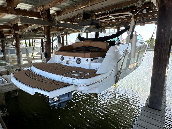 Four Winns HD8 2023 Four Winns HD8 boat docked in a covered marina, rear view.