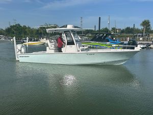 Sportsman Masters 267OE Bay Boat 2023 Sportsman Masters 267OE Bay Boat on calm water, docked at a marina.