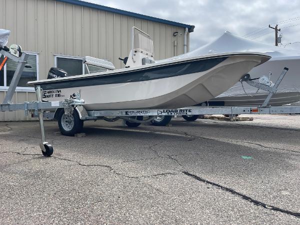 Carolina Skiff E16 JVX CC 2025 Carolina Skiff E16 JVX CC boat on trailer, parked outside a building.