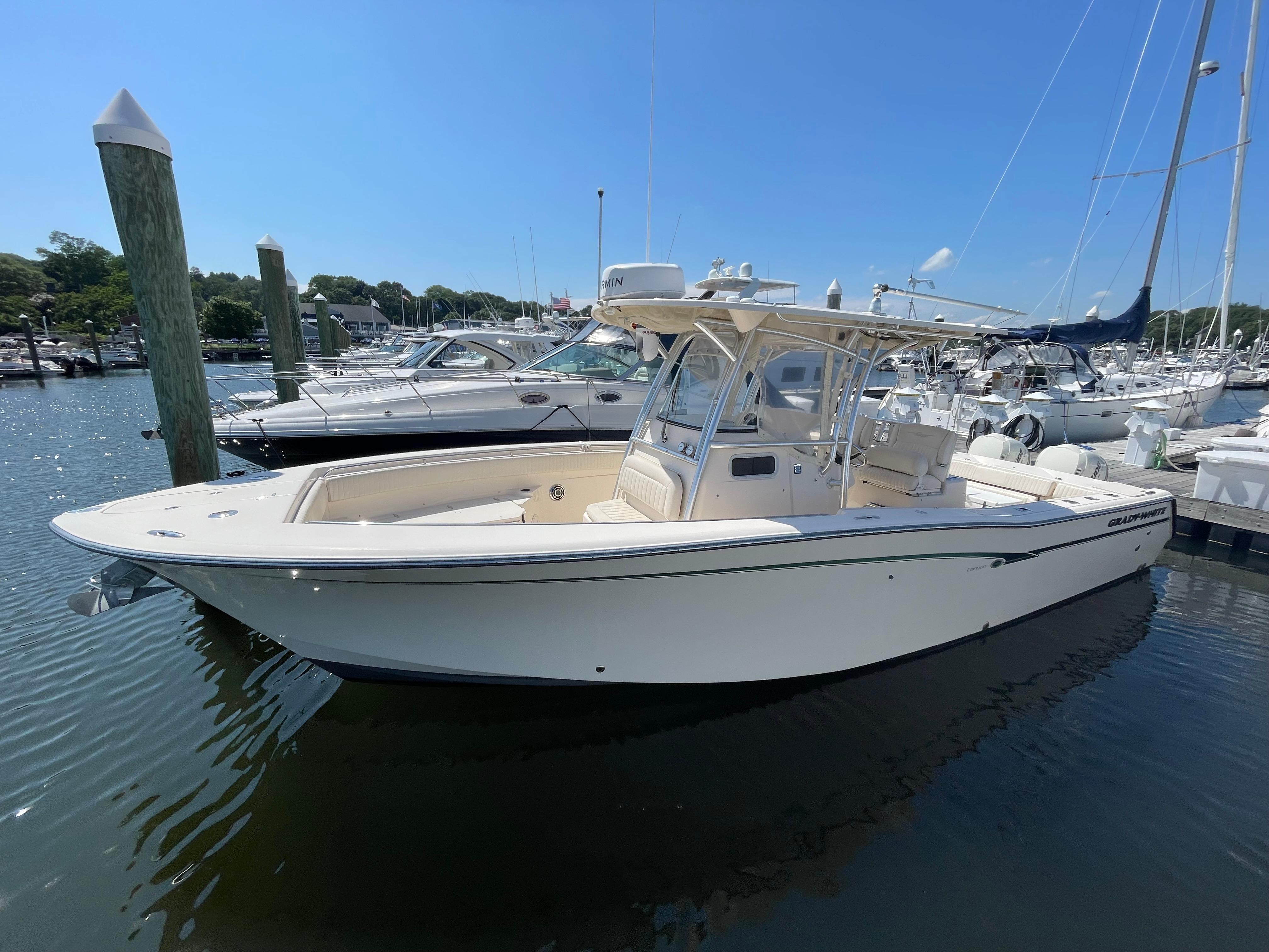 Grady-White Canyon 306 2014 Grady-White Canyon 306 boat docked in a marina under clear blue sky.