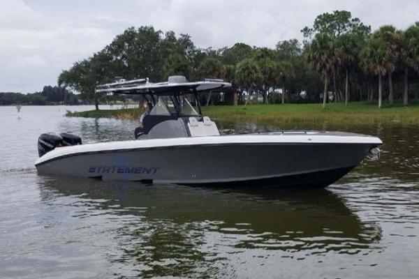 Statement 350 Open 2019 Statement 350 Open boat on a calm lake with trees in the background.