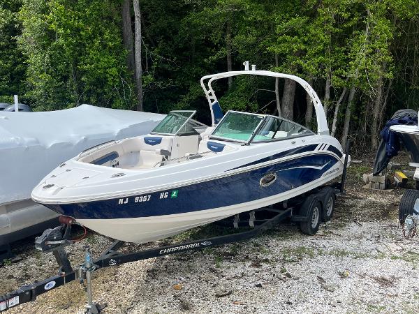 Chaparral Vortex 243 2018 Chaparral Vortex 243 boat on trailer, parked outdoors near trees.