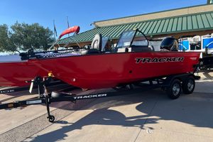 Tracker Super Guide V-16 SC 2026 Tracker Super Guide V-16 SC boat, red, on trailer, parked outdoors.