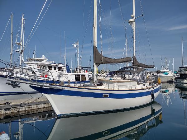 Islander Freeport 41 1979 Islander Freeport 41 sailboat docked in a marina, reflecting on calm water.