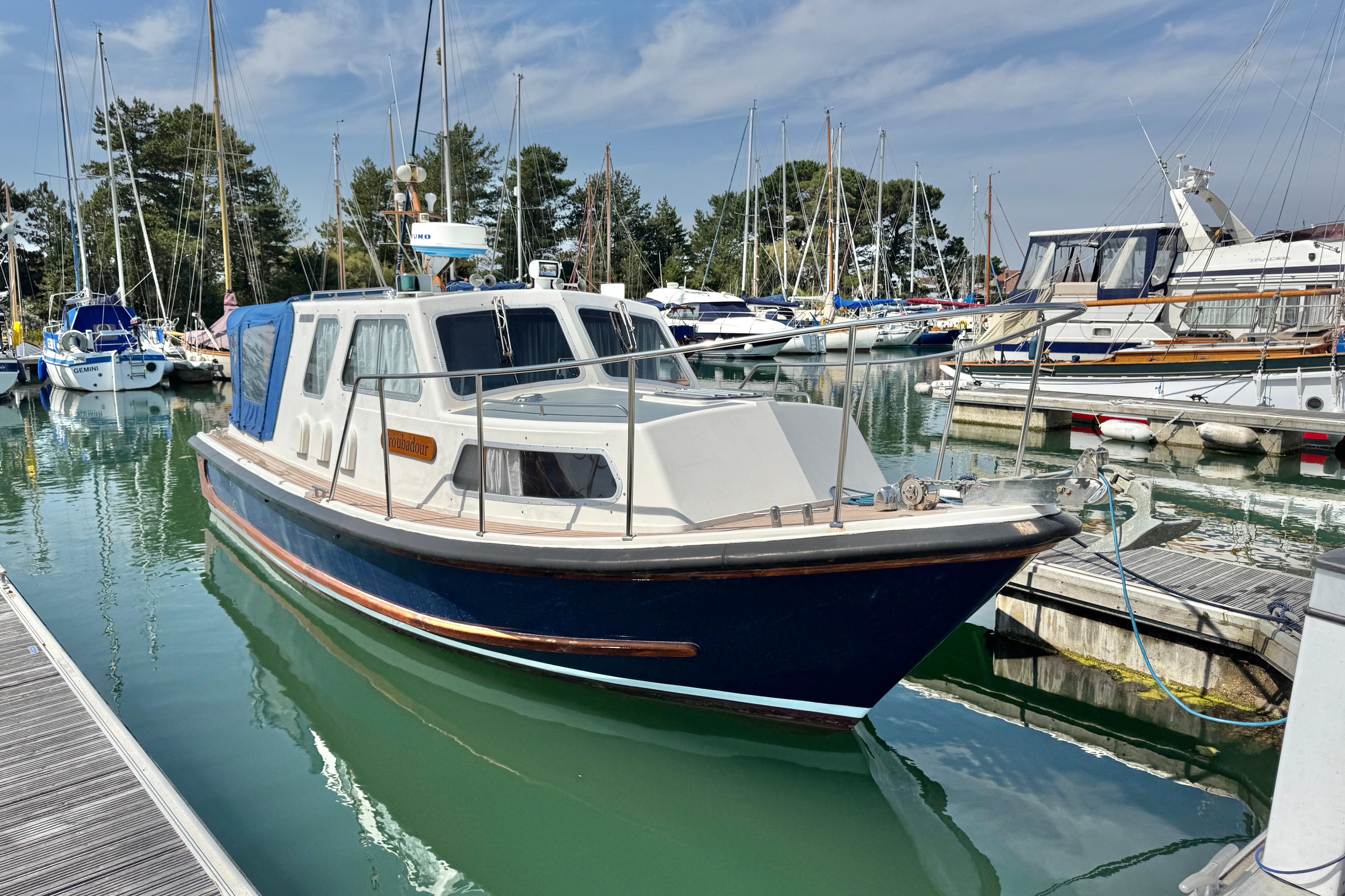 Nelson 28 Nelson 28 boat, 1993 model, docked in a marina with other vessels.