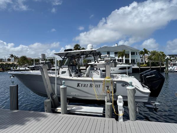 Sea Fox 328 Commander 2023 Sea Fox 328 Commander boat docked at marina under blue sky.