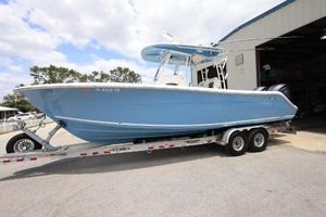 Cobia 301 Center Console 2022 Cobia 301 Center Console boat on trailer outside a warehouse.