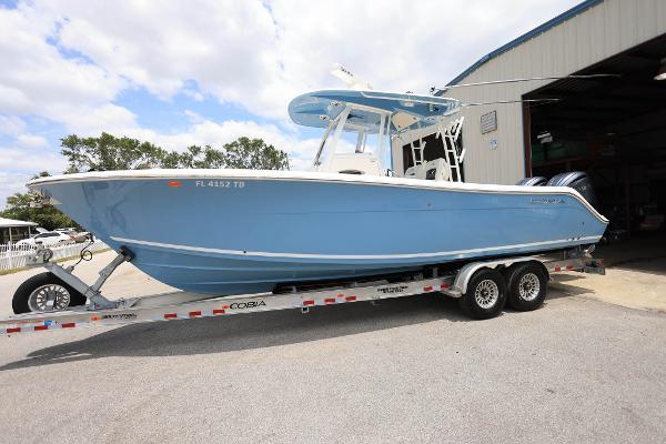 Cobia 301 Center Console 2022 Cobia 301 Center Console boat on trailer outside a warehouse.