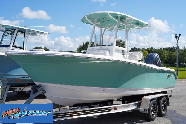 Sea Hunt Ultra 219 2025 Sea Hunt Ultra 219 boat on trailer, light blue hull, sunny day.