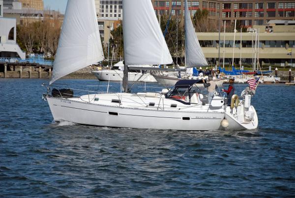 Beneteau 361 2001 Beneteau 361 sailboat cruising in a marina with sails up.