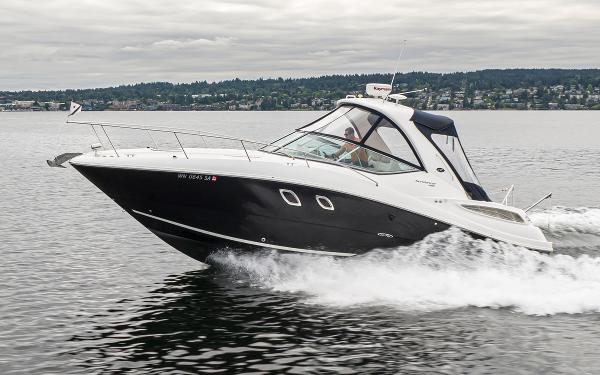 Sea Ray Sundancer 330 2011 Sea Ray Sundancer 330 cruising on a calm lake.