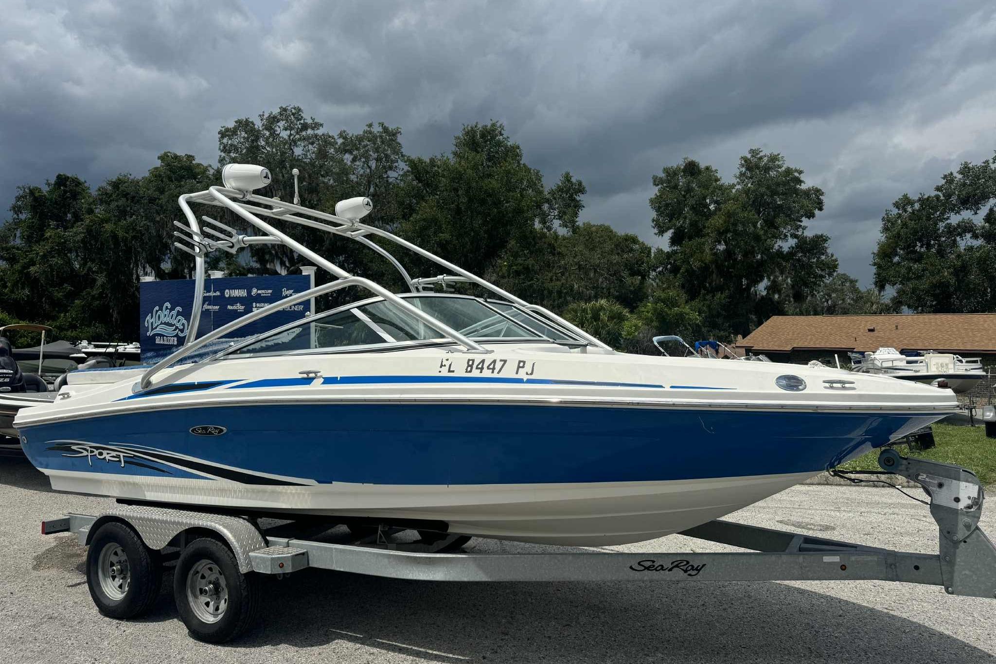 Sea Ray 205 Sport 2011 Sea Ray 205 Sport boat on trailer, blue and white design, parked outdoors.