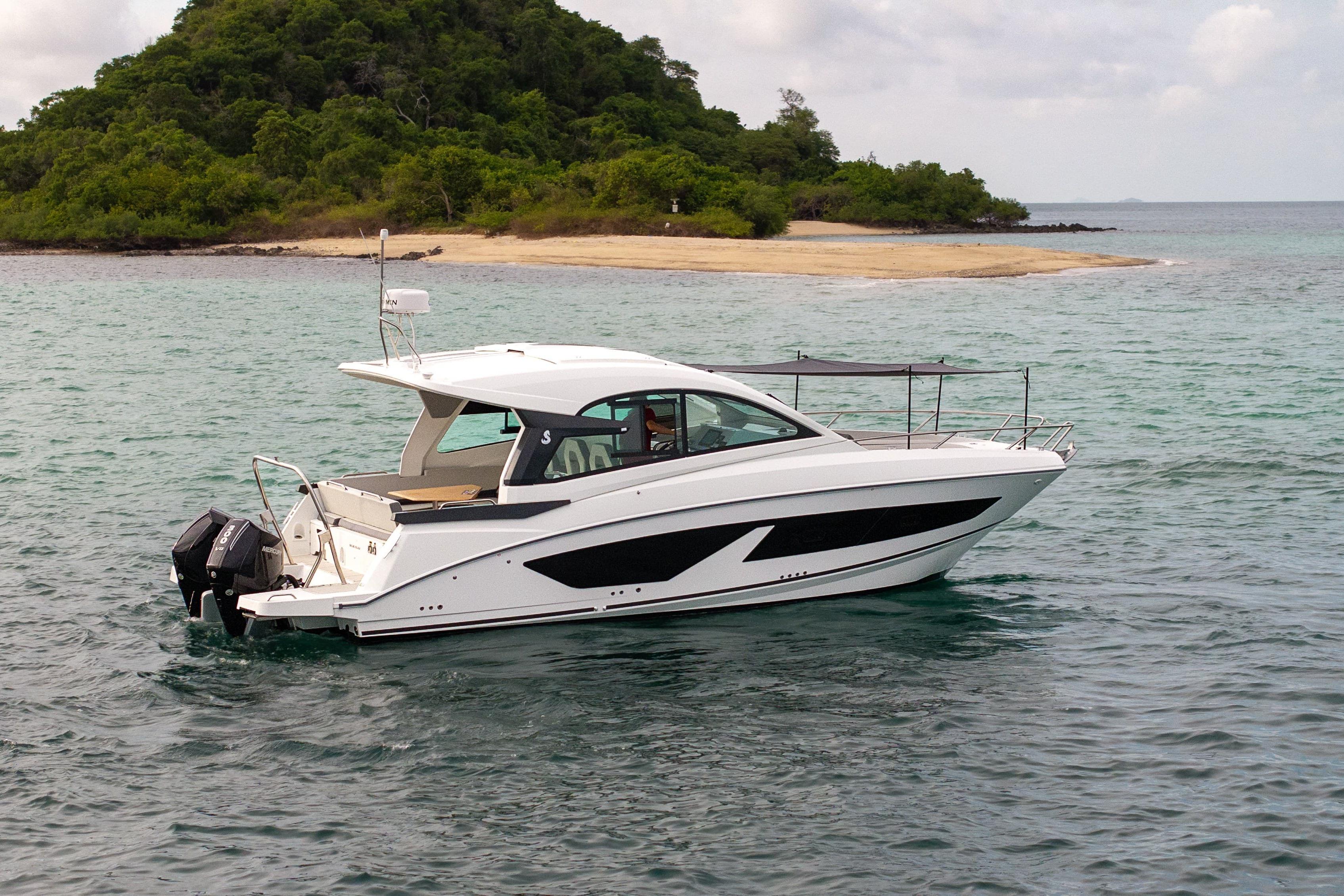 Beneteau Gran Turismo 32 2025 Beneteau Gran Turismo 32 yacht cruising near a lush island.